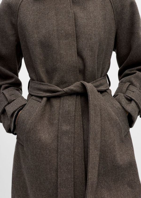 Brown coat with a belt on a light gray background