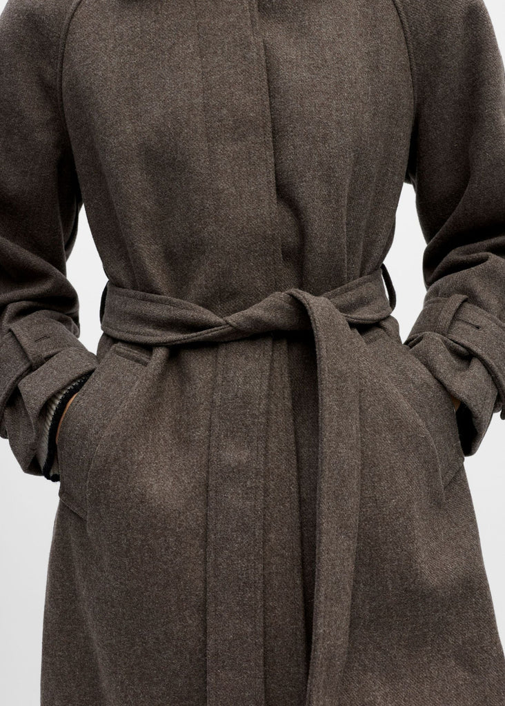 Brown coat with a belt on a light gray background