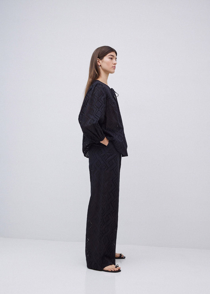 Woman wearing a black outfit on a white background