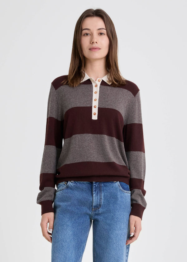 Woman wearing a striped sweater and jeans on a white background
