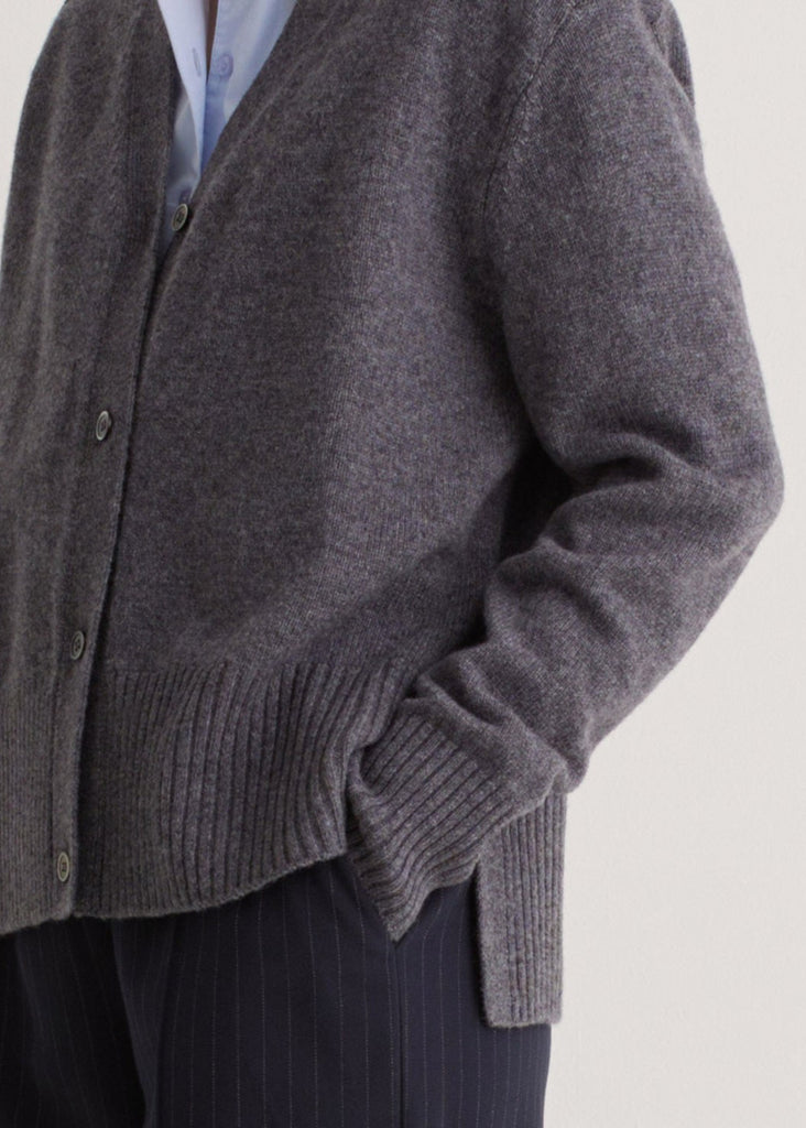 Gray cardigan worn by a person on a light gray background