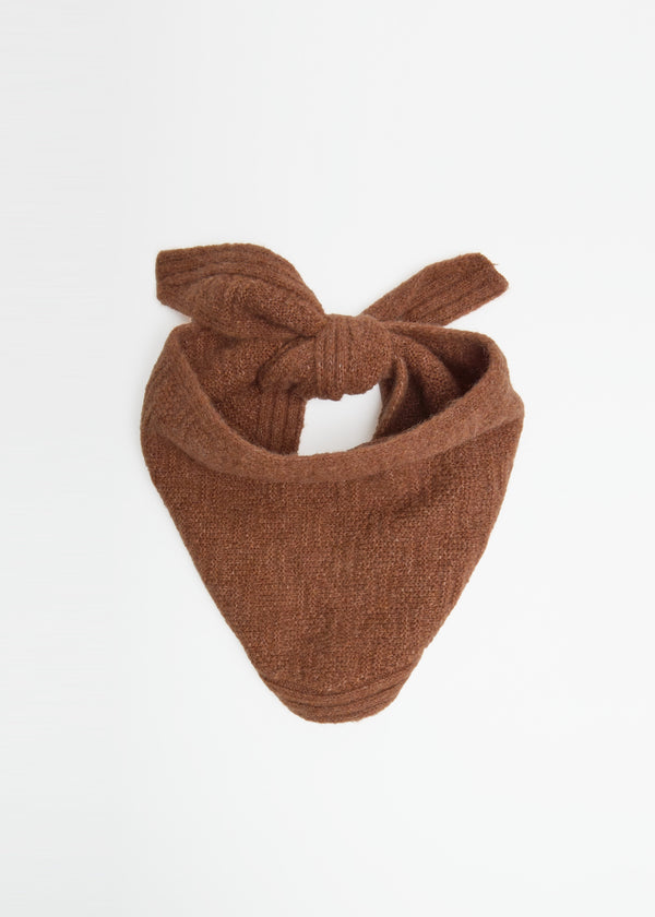 Brown knotted headband on a white background