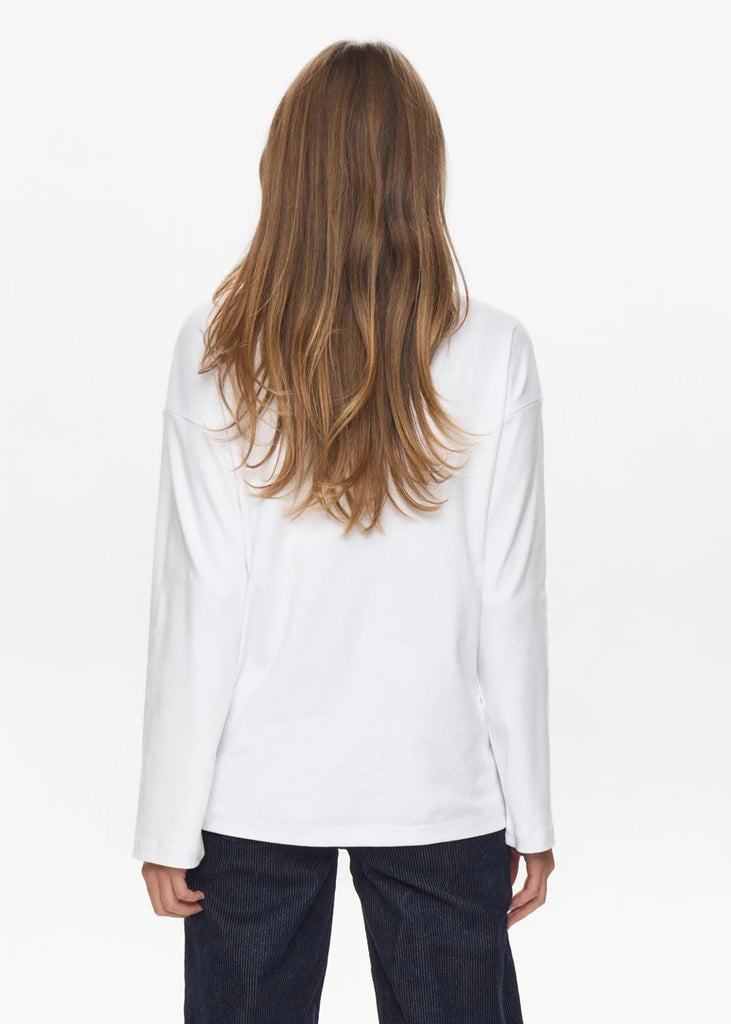 Person wearing a white blouse and dark pants on a white background