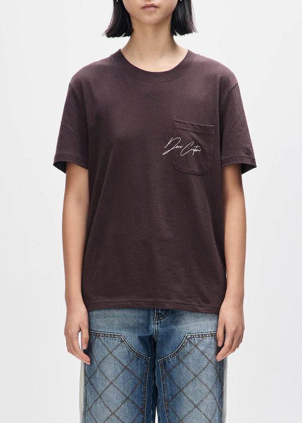 Person wearing a brown t-shirt with a logo on a white background