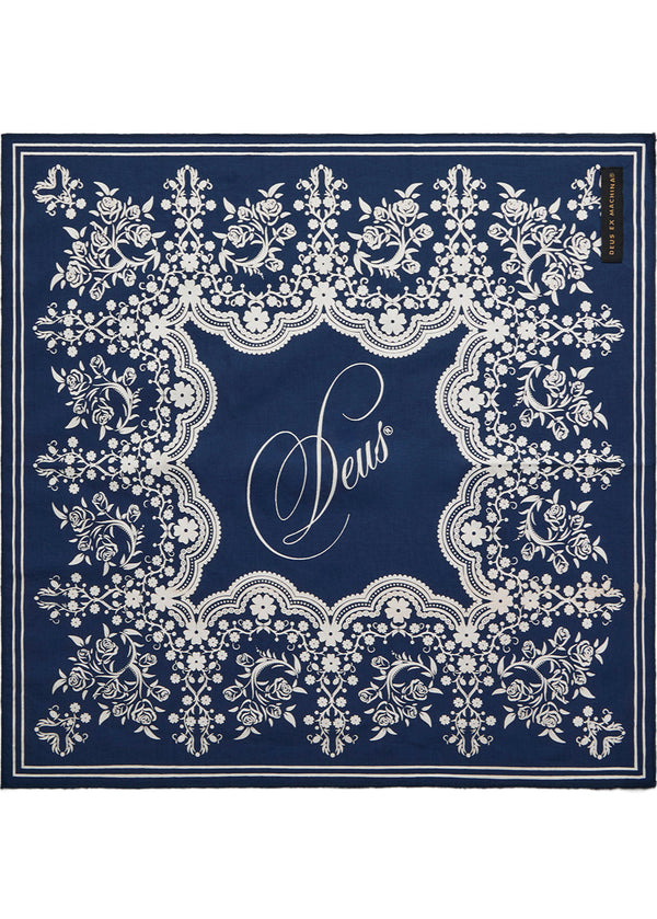 Navy blue scarf with white lace pattern and 'Seus' branding on a white background