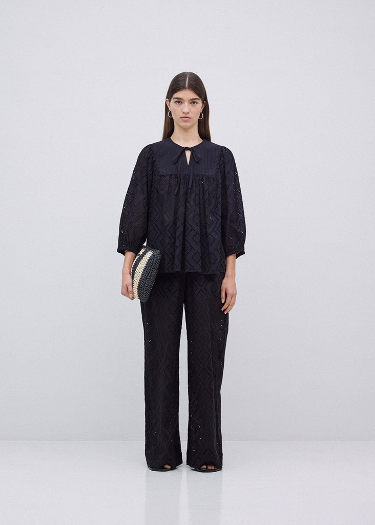 Woman wearing a black outfit with a white background