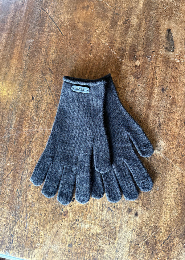 Pair of gray gloves on a wooden surface