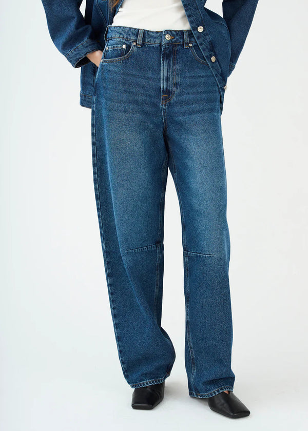 Person wearing blue jeans on a white background