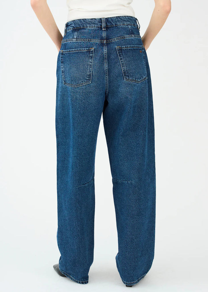 Blue jeans worn by a person on a white background