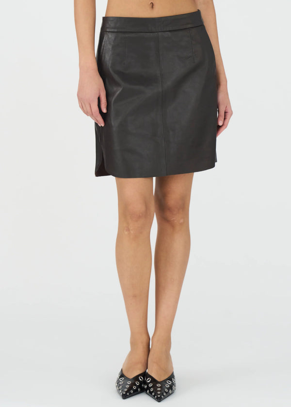 brown leather skirt worn by a person on a white background