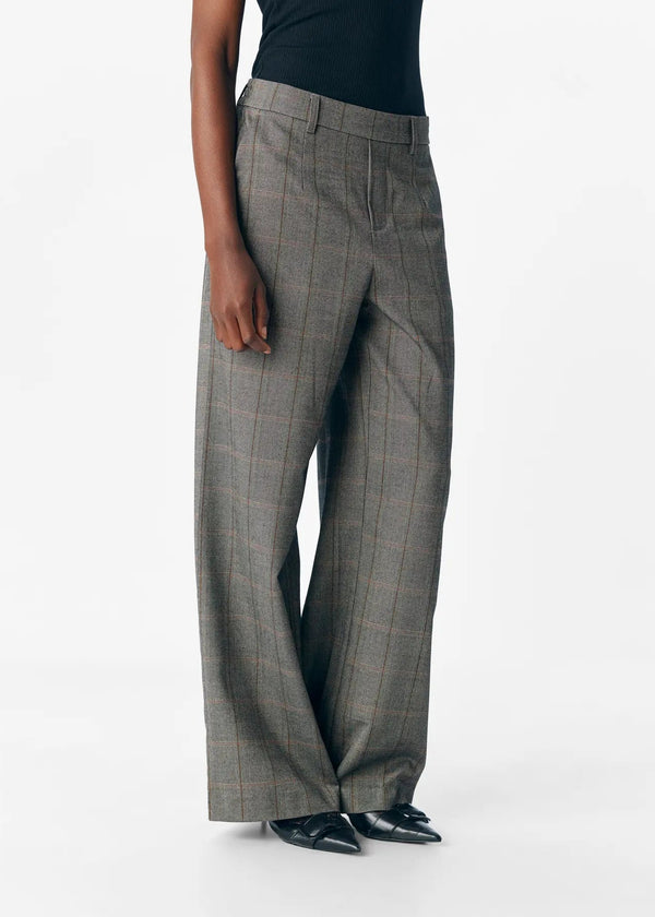 Gray plaid pants worn by a person on a white background