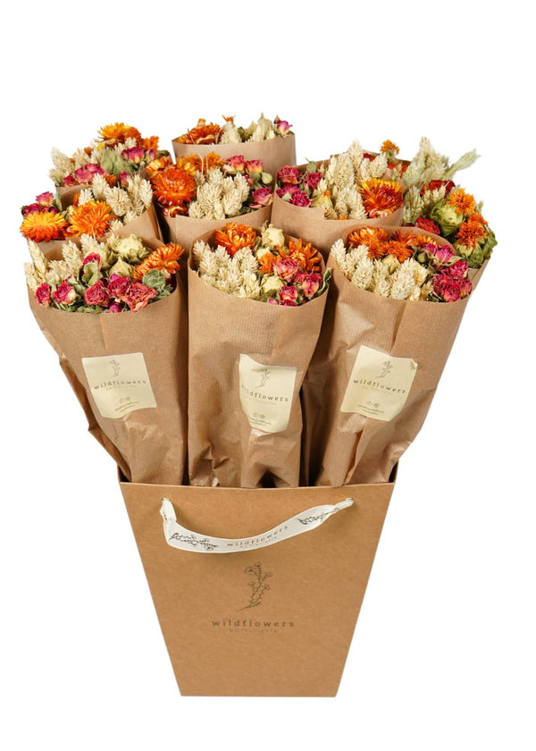 Bouquets of flowers in brown paper bags with a visible brand logo on a white background