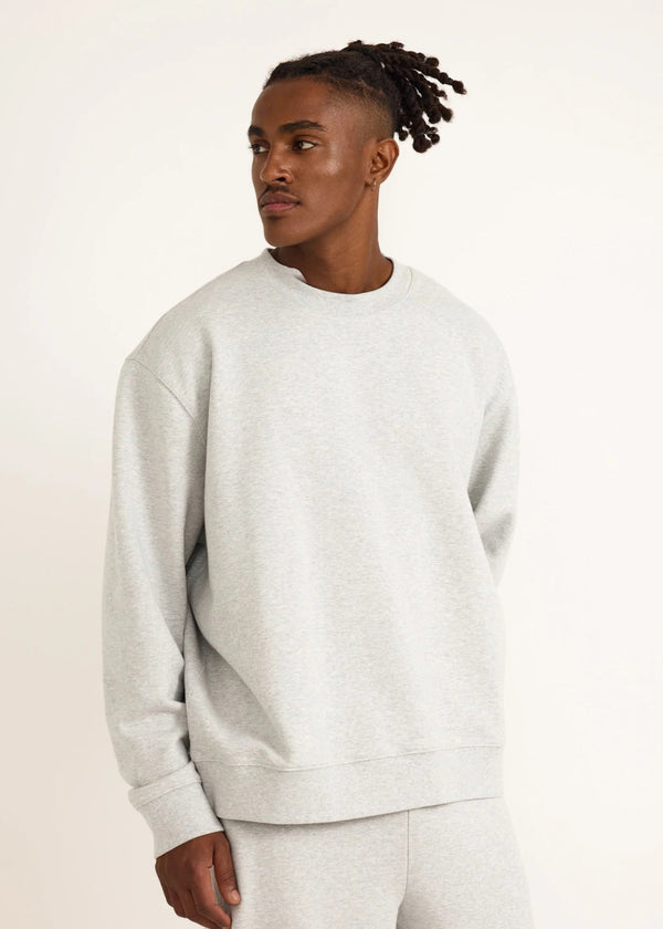 Man wearing a gray sweatshirt on a white background