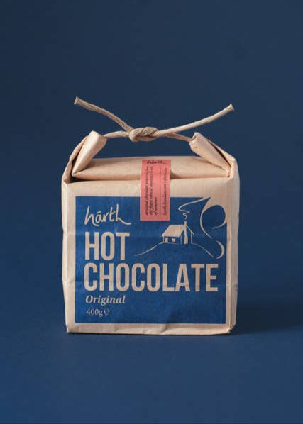 Box of hot chocolate with a blue label on a dark background