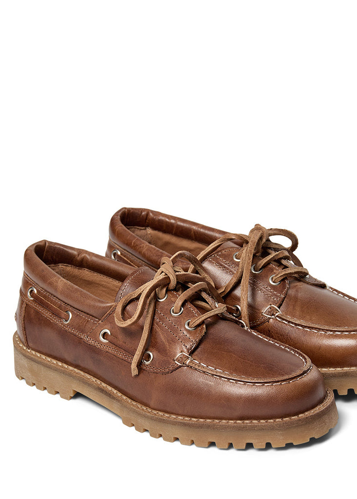 Pair of brown leather shoes on a white background