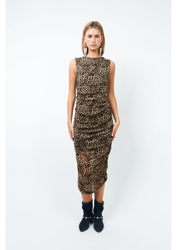 Woman wearing a leopard print dress on a white background