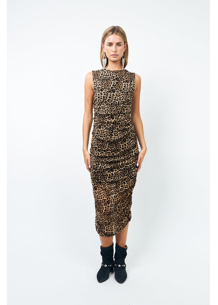 Woman wearing a leopard print dress on a white background