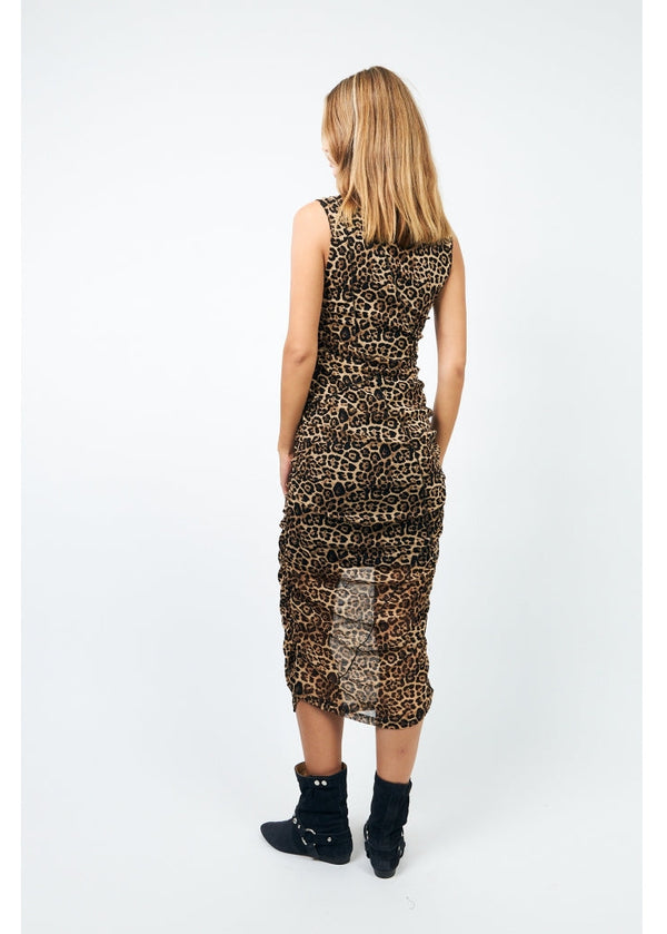 Woman wearing a leopard print dress on a white background