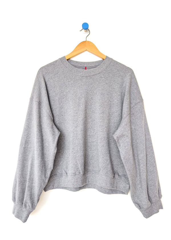 Gray sweatshirt on a hanger against a white background