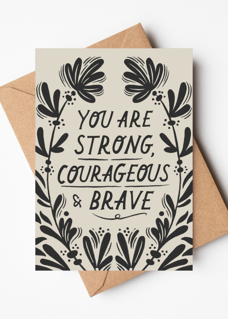 Motivational card with floral design and text 'You are strong, courageous & brave' on a white background.
