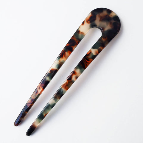 Tortoiseshell hair clip on a white background
