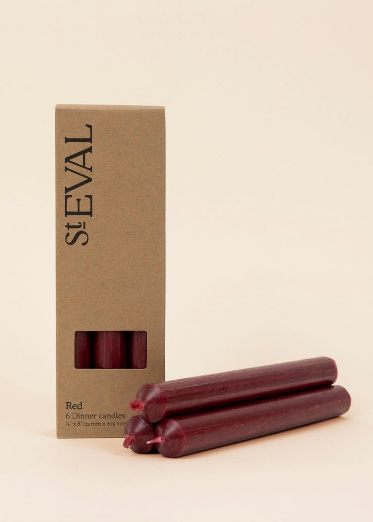 Red dinner candles with a St Eval box on a beige background