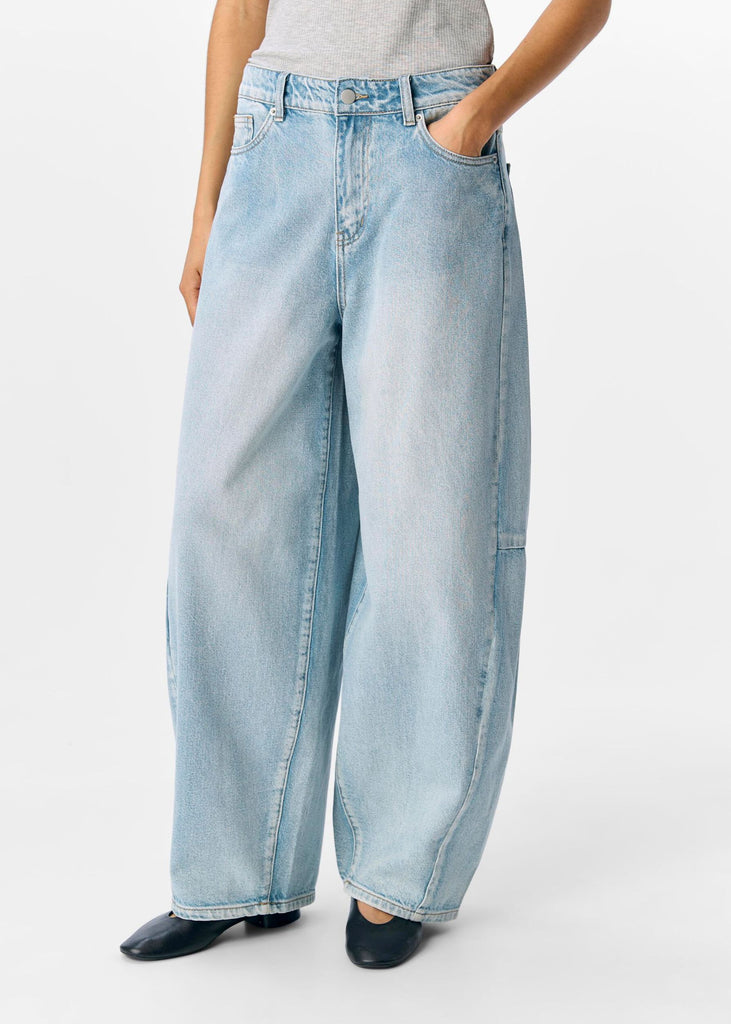 Light blue jeans worn by a person on a white background