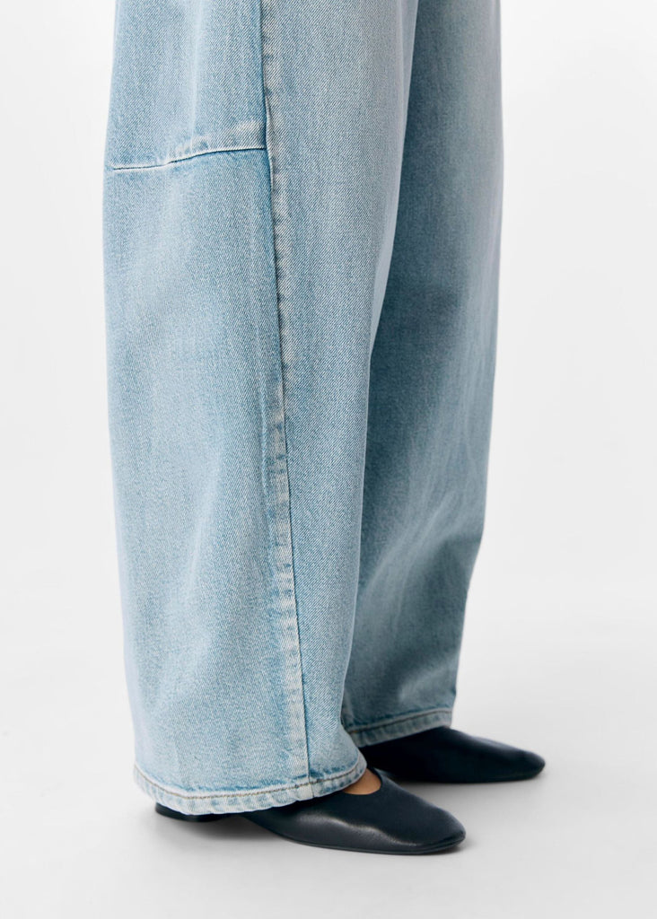 Light blue jeans worn by a person on a white background