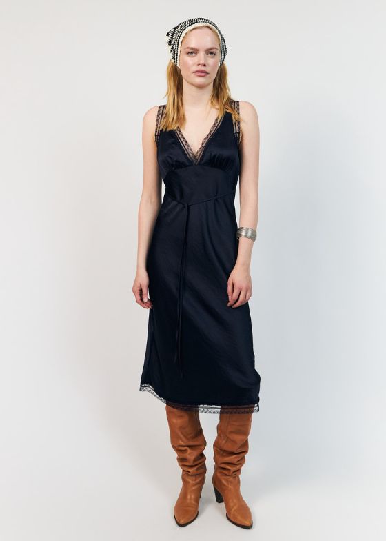 The Clari dress from Lollys Laundry is an elegant midi dress. The dress drapes softly along the body and features a deep V neckline finished with a delicate lace trim