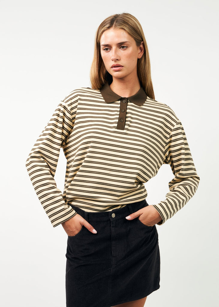 Woman wearing a striped shirt with a collar and black skirt on a white background