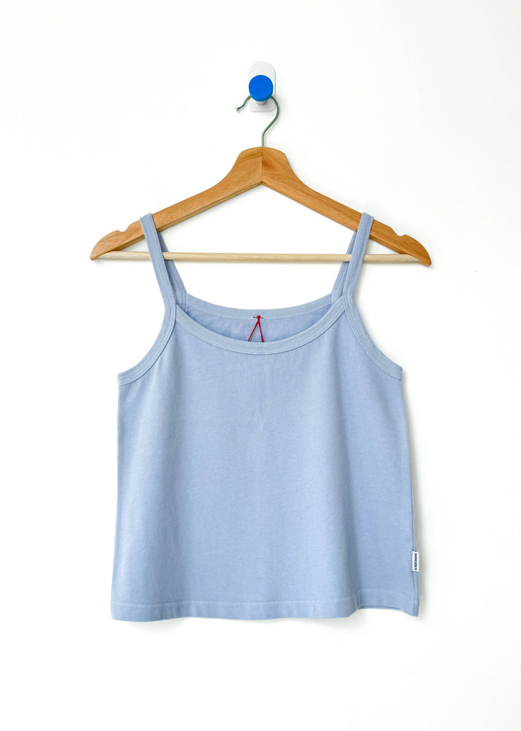 Light blue tank top on a wooden hanger against a white background
