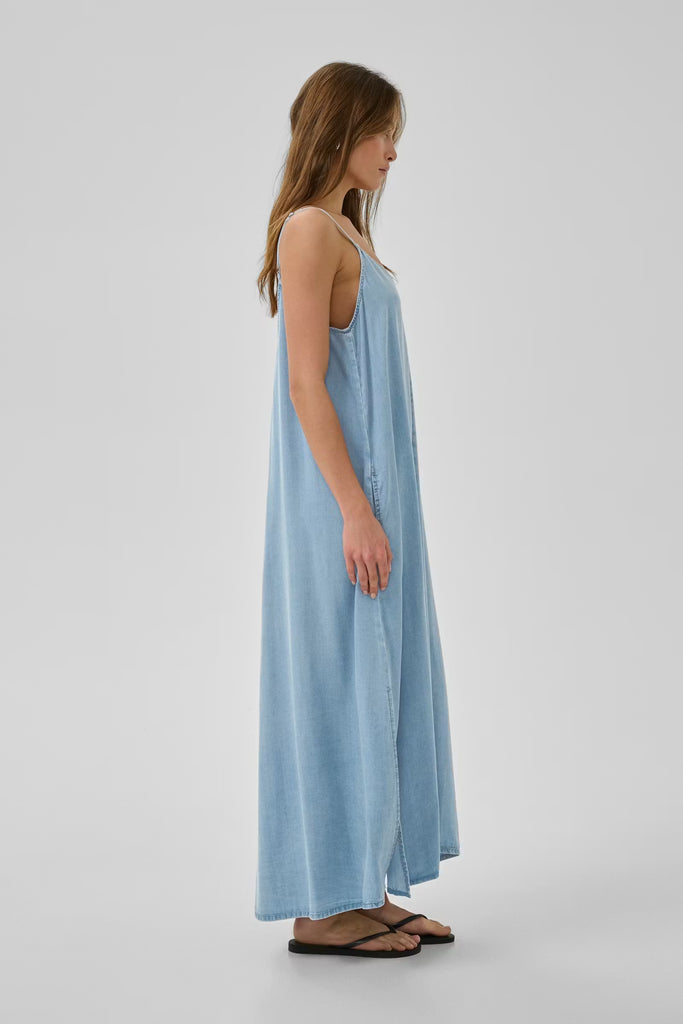 Woman wearing a light blue dress on a white background