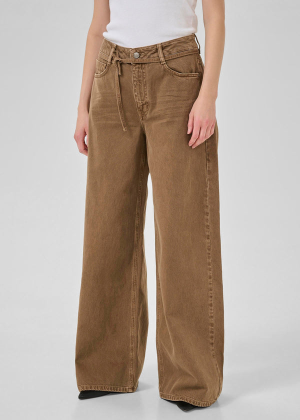 Brown wide-leg pants worn by a person on a white background