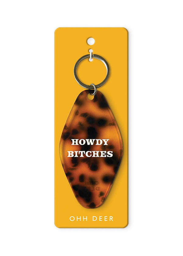 Tortoiseshell keychain with 'HOWDY BITCHES' text on a yellow card, brand 'Ooh Deer' visible