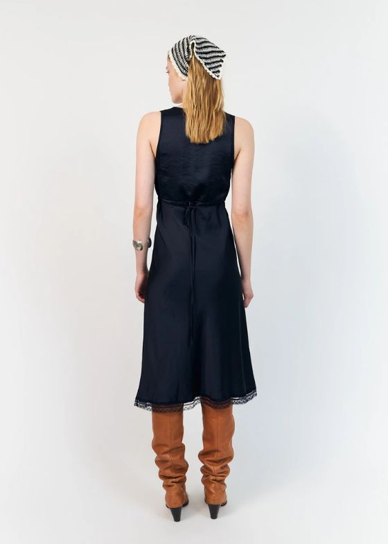 The Clari dress from Lollys Laundry is an elegant midi dress. The dress drapes softly along the body and features a deep V neckline finished with a delicate lace trim