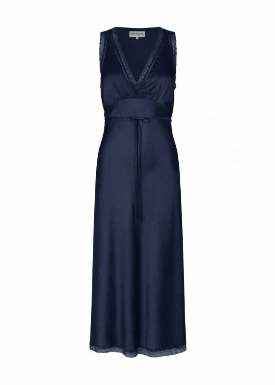 The Clari dress from Lollys Laundry is an elegant midi dress. The dress drapes softly along the body and features a deep V neckline finished with a delicate lace trim