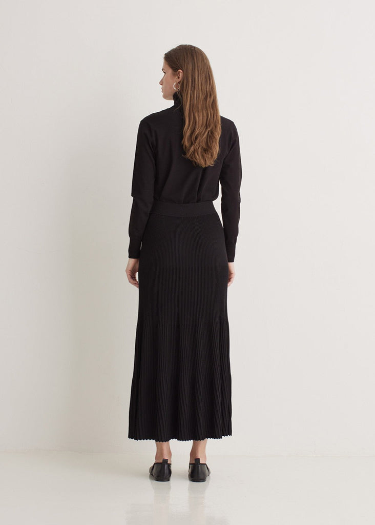 Woman wearing a black dress with a white background