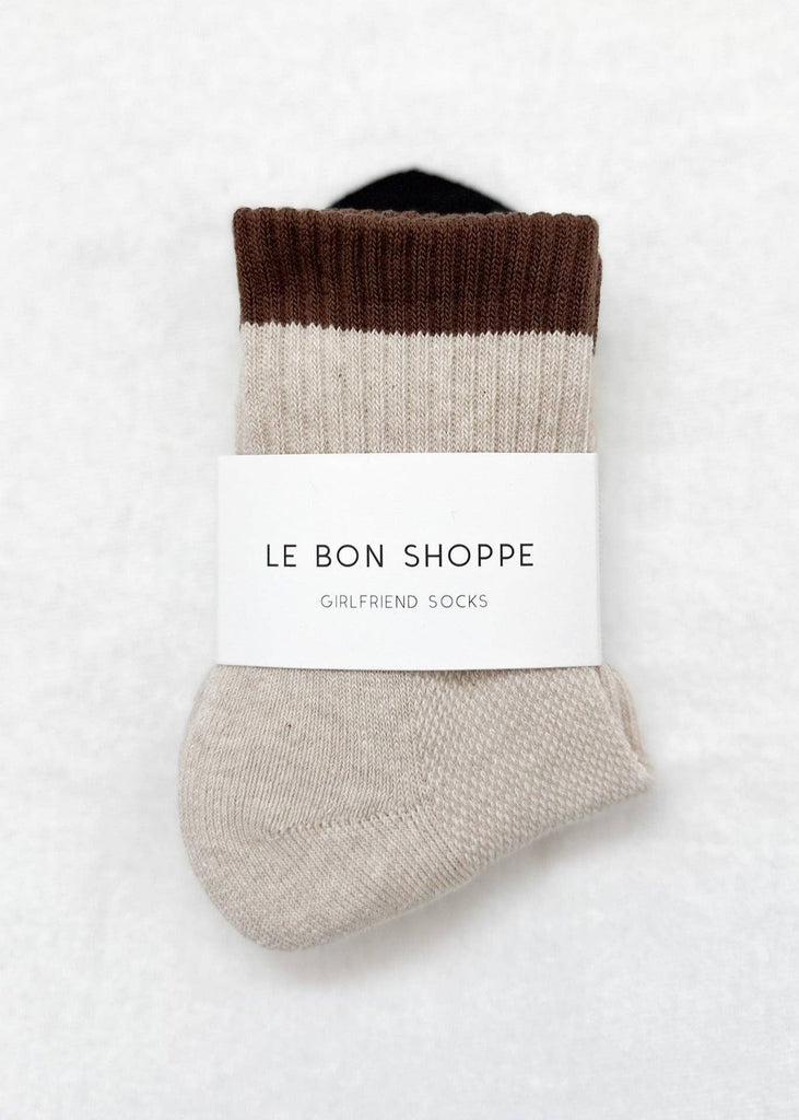 Pair of color-blocked socks with a label on a white background