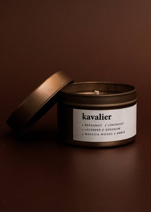 Candle in a tin with 'kavalier' label on a brown background