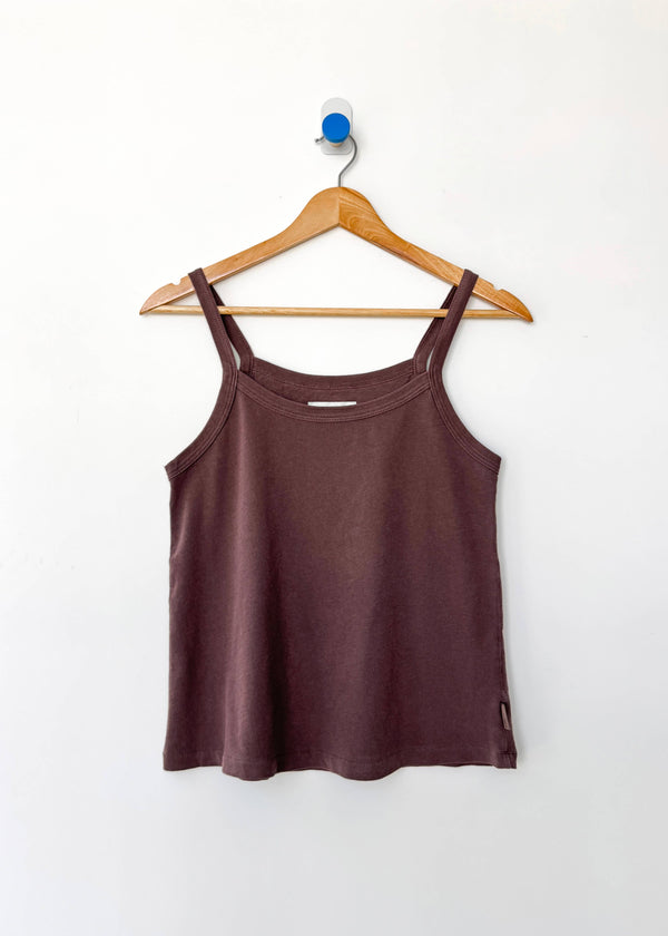 Brown tank top on a wooden hanger against a white background
