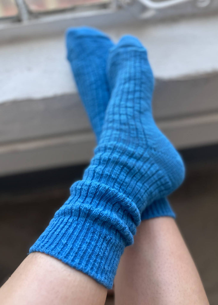 Blue socks being worn with a blurred background