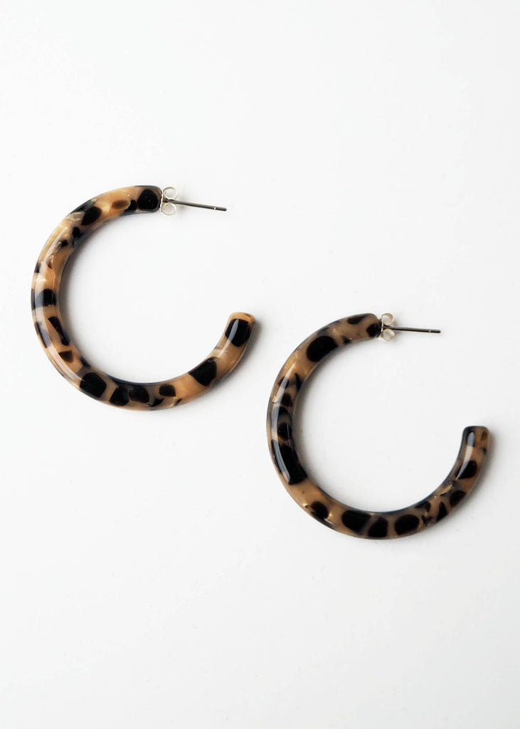 Leopard print hoop earrings on a white background