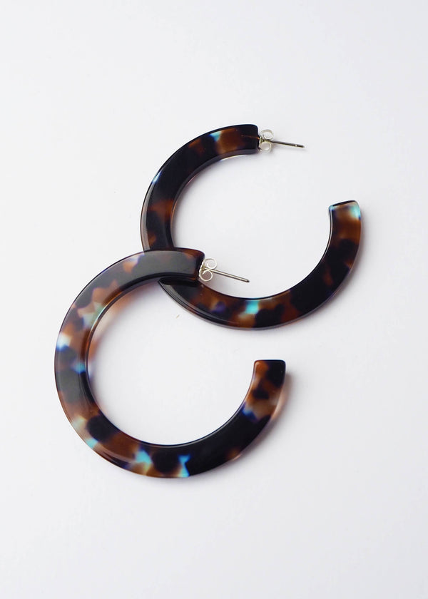 Tortoiseshell hoop earrings on a white background