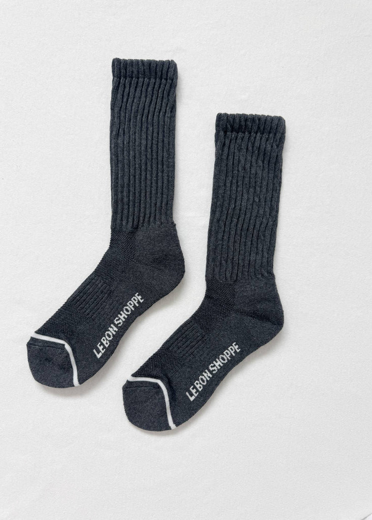 Pair of dark gray socks with 'LEbON SHOPPE' branding on a light gray background