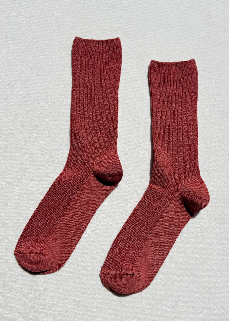 Pair of red socks on a light gray background