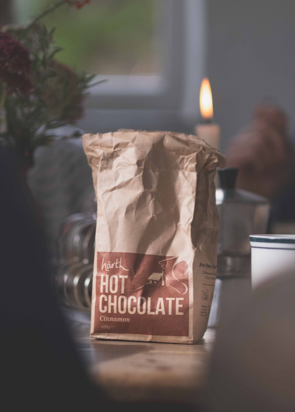 Härtl Hot Chocolate bag on a table with blurred background