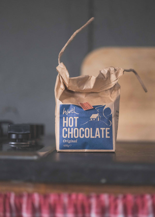 Bag of hot chocolate on a rustic surface with a blurred background