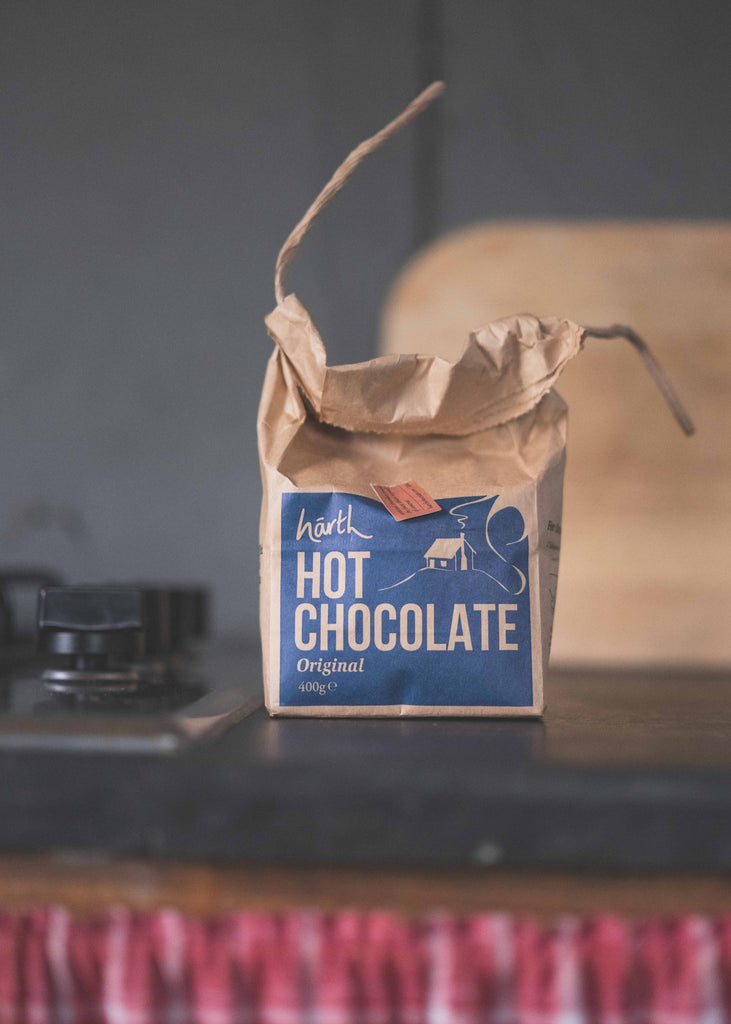 Bag of hot chocolate on a rustic surface with a blurred background