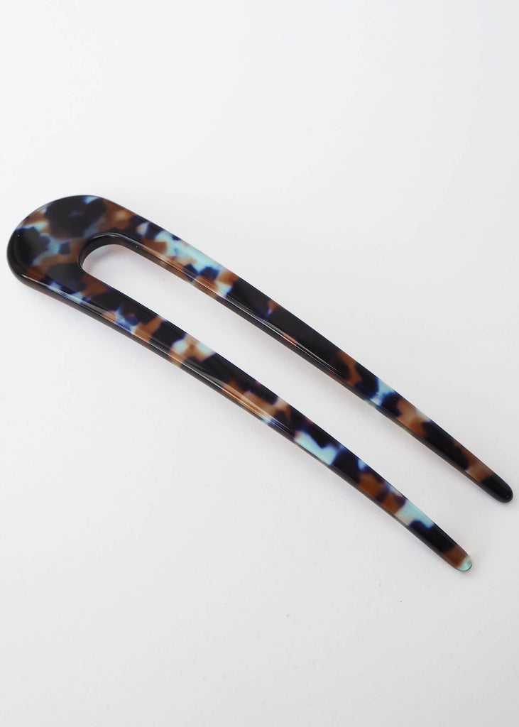 Tortoiseshell patterned hair clip on a white background