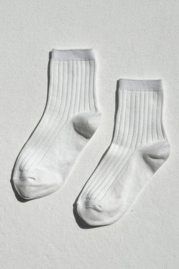 Pair of white socks on a light gray background